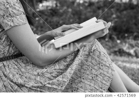 Young woman reading bible in natural park Young woman reading bible in natural park 42571569