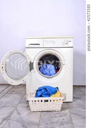 Clothes in basket and washing machine Clothes in basket and washing machine 42571585