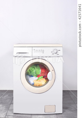Dirty clothes washed on washing machine Dirty clothes washed on washing machine 42571641