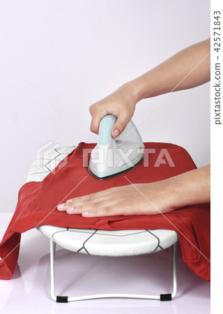 People ironing colored clothes on ironing board People ironing colored clothes on ironing board 42571843