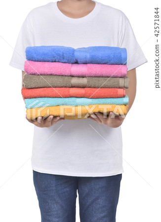 Male hand holding colorful towels pile Male hand holding colorful towels pile 42571844