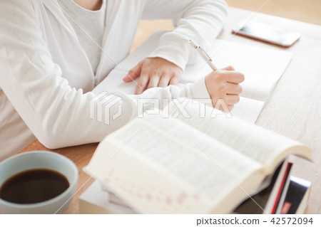 A woman studying qualifications A woman studying qualifications 42572094