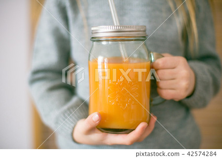 Cute little girl with glass of orange juice  42574284