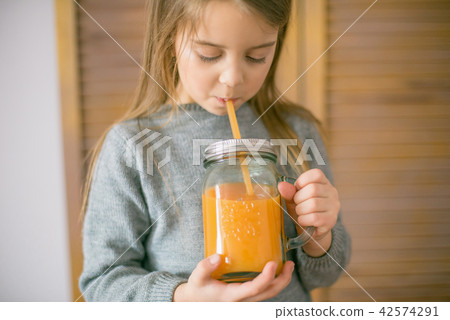 Cute little girl with glass of orange juice Cute little girl with glass of orange juice 42574291