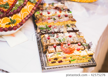 Delicious sweets on wedding candy buffet with desserts, cupcakes 42575276