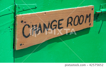 Wooden signage outside the room. Apparel changing 42575652