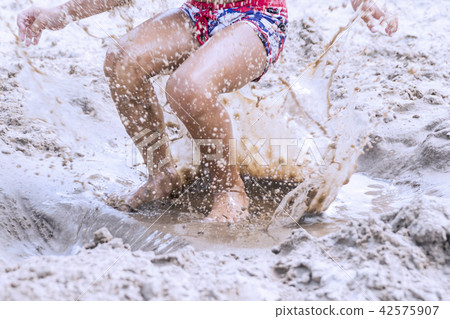 Playing with sand on the beach Playing with sand on the beach 42575907