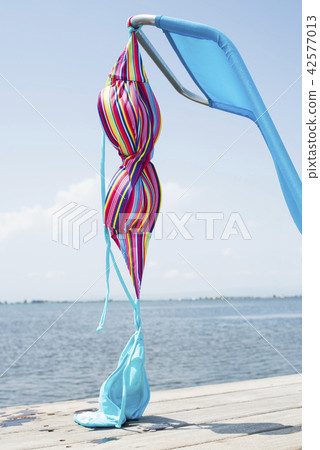 bikini drying on a deck chair on a pier bikini drying on a deck chair on a pier 42577013