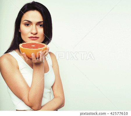 beauty young brunette woman with grapefruit isolated on white ba beauty young brunette woman with grapefruit isolated on white ba 42577610
