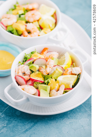 Salad with prawns in bowls on table Salad with prawns in bowls on table 42578609