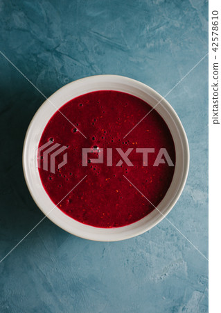 Red fruity smoothie in bowl 42578610
