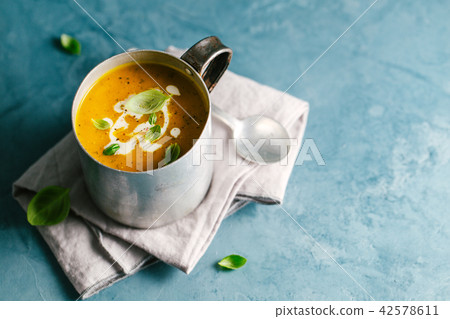 Tasty creamy pumpkin soup in mug Tasty creamy pumpkin soup in mug 42578611