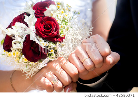 Happy bride and groom on their wedding hugging 42580371