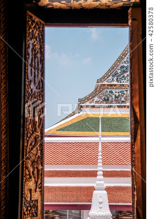 Thai Temple roof and facade seen through window Thai Temple roof and facade seen through window 42580378