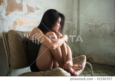 Sad Asian girl in dirty room 42580767