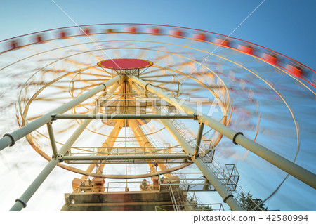 Motion Blur Ferris Wheel at Sunset Motion Blur Ferris Wheel at Sunset 42580994