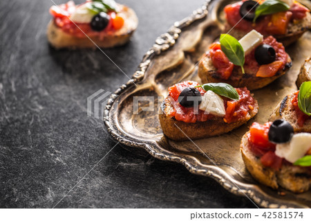 Bruschetta toast with mozzarella tomatoes olives Bruschetta toast with mozzarella tomatoes olives 42581574