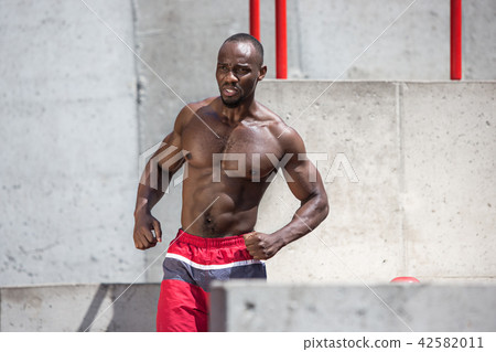 Athlete doing exercises at stadium Athlete doing exercises at stadium 42582011