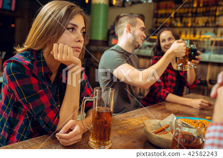 people, leisure, friendship and communication concept - happy friends drinking beer, talking and people, leisure, friendship and communication concept - happy friends drinking beer, talking and 42582243
