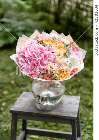 Beautiful pink summer bouquet on wooden table. Arrangement with mix flowers. The concept of a flower 42583034