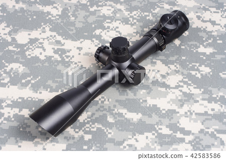sniper scope on camouflage background 42583586
