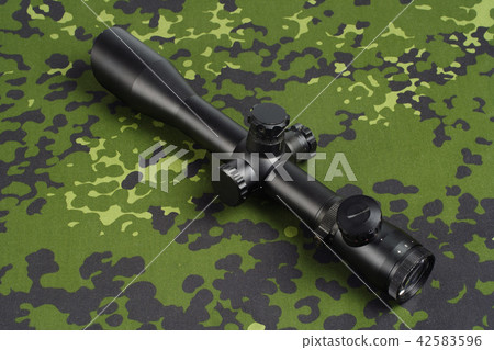sniper scope on camouflage background 42583596