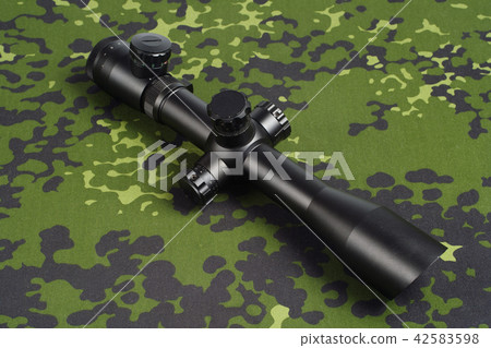 sniper scope on camouflage background 42583598