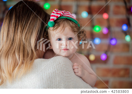 Beautiful little baby boy in elf hat and mother 42583803