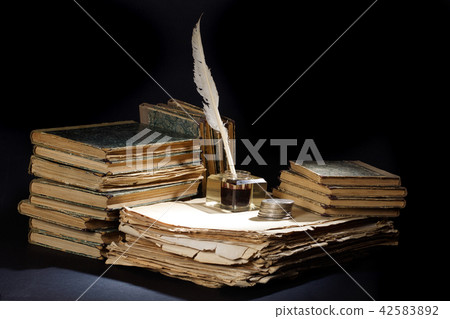 Old fountain pen, books and inkwell on black Old fountain pen, books and inkwell on black 42583892