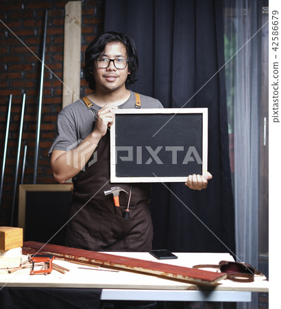 Asian Carpenter Working in Woodworking Workshop Asian Carpenter Working in Woodworking Workshop 42586679