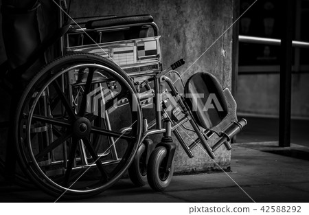 Wheelchair folded beside the wall. Hospital scene Wheelchair folded beside the wall. Hospital scene 42588292