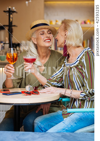 Nice lesbian couple sitting in the restaurant 42593285