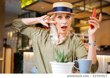 Joyful nice woman visiting cafe Joyful nice woman visiting cafe 42593927