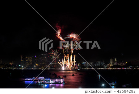 Fireworks explored over cityscape at night in sea Fireworks explored over cityscape at night in sea 42594292