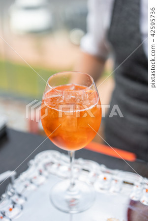 Aperol spritz cocktail in misted glass, selective focus. Alcoholic beverage based on bar counter Aperol spritz cocktail in misted glass, selective focus. Alcoholic beverage based on bar counter 42595736