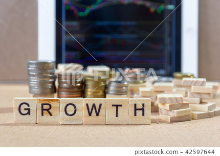 GROWTH word wood block on tablets with coin  42597644