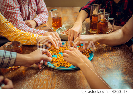 people, leisure, friendship and communication concept - happy friends drinking beer, talking and people, leisure, friendship and communication concept - happy friends drinking beer, talking and 42601183