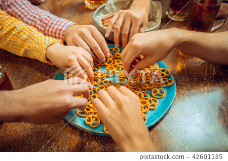 people, leisure, friendship and communication concept - happy friends drinking beer, talking and people, leisure, friendship and communication concept - happy friends drinking beer, talking and 42601185