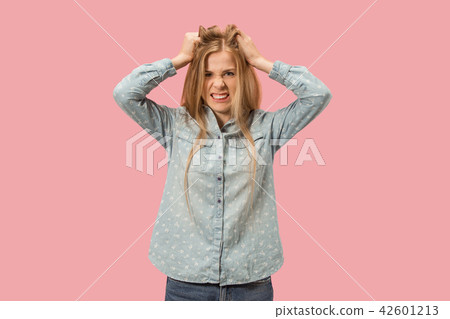 Portrait of an angry woman looking at camera isolated on a pink background 42601213