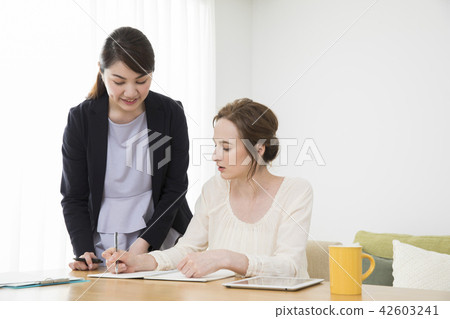 A Japanese woman talking to a foreign woman A Japanese woman talking to a foreign woman 42603241