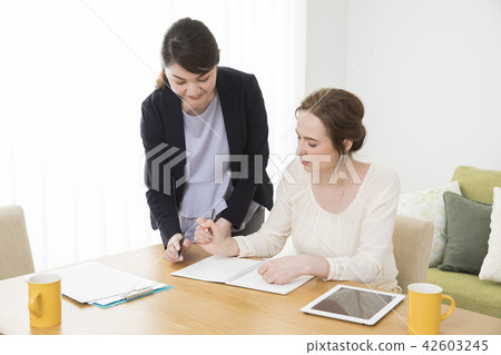 A Japanese woman talking to a foreign woman A Japanese woman talking to a foreign woman 42603245