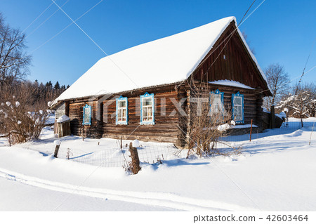 old typical rural house in sunny winter day old typical rural house in sunny winter day 42603464