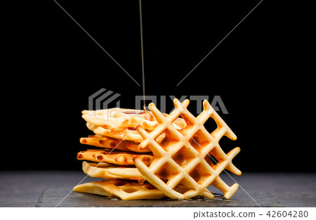 Photo of Viennese wafers with honey on an black background Photo of Viennese wafers with honey on an black background 42604280