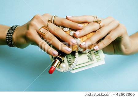 woman hands holding hamburger with money, jewelry, cosmetic, soc 42608000