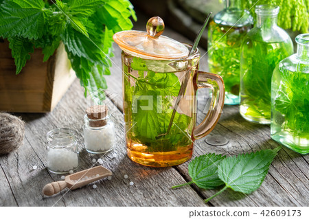 Nettle tea, infusion bottle, homeopathic globules. Nettle tea, infusion bottle, homeopathic globules. 42609173