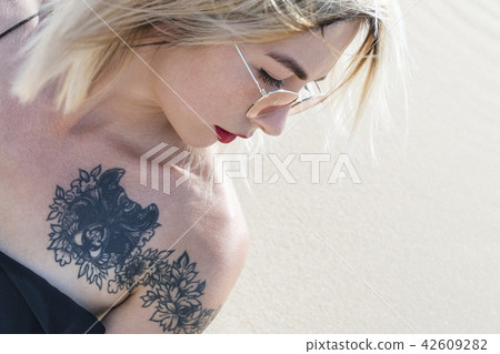Female shoulder with tattoo Female shoulder with tattoo 42609282