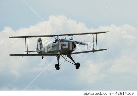Biplane flying in sky Biplane flying in sky 42614169