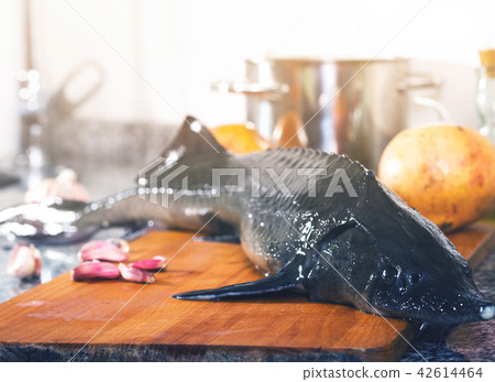 Sturgeon fish on stone surface with pomegranates 42614464