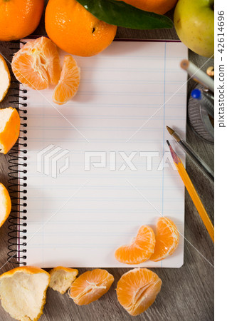 Notebook surrounded by fruit 42614696