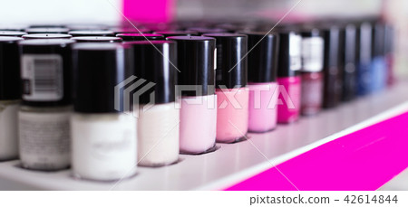 Variety of nail polishes on showcase in cosmetic boutique Variety of nail polishes on showcase in cosmetic boutique 42614844
